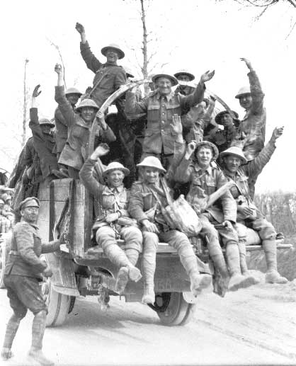 A group of Canadian soldiers on a truck waving.