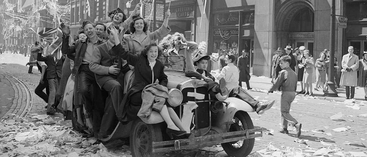 A group of people riding in an older car